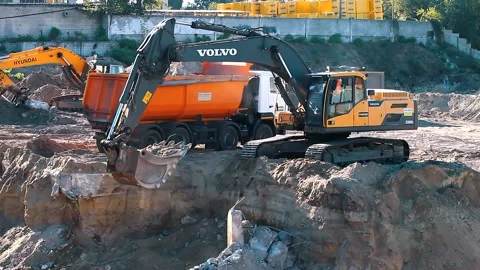 The excavator loading crushed stone into a dump truck in a crushed stone quarry Stock Footage 228733242