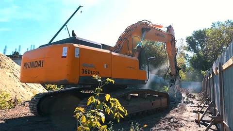 The excavator loading crushed stone into a dump truck in a crushed stone quarry Stock Footage 228733287