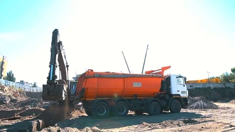 The excavator loading crushed stone into a dump truck in a crushed stone quarry Stock Footage 228733374
