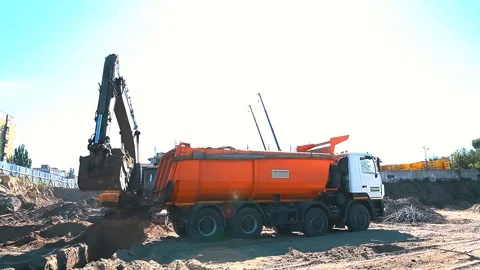 The excavator loading crushed stone into a dump truck in a crushed stone quarry Stock Footage 228733406