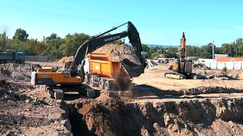 The excavator loading crushed stone into a dump truck in a crushed stone quarry Stock Footage 228733489