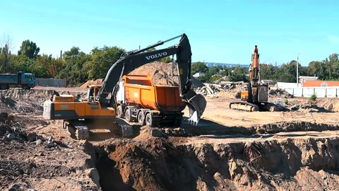 The excavator loading crushed stone into a dump truck in a crushed stone quarry Stock Footage 228733531
