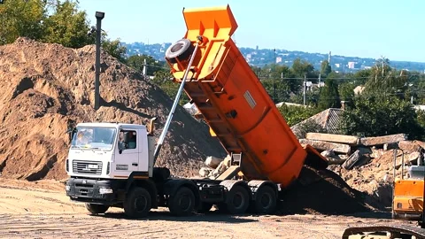 The excavator loading crushed stone into a dump truck in a crushed stone quarry Stock Footage 228733619