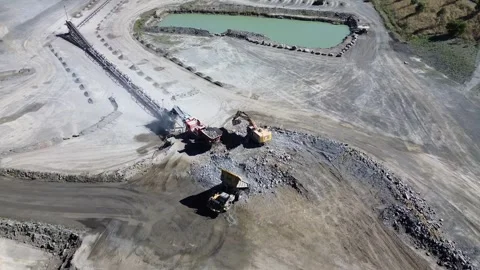 Excavator Loading Crusher with Dump Truck Stock Footage 332749926