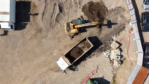 Excavator loading a dump truck with earth on a construction site Video stock 343291550