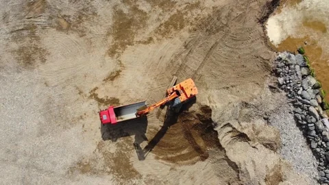 Excavator loading dump truck with sand on construction site Stock Footage 285653585
