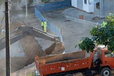 Excavator loading a dump truck with soil Stock Photos