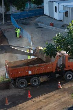 Excavator loading a dump truck with soil Stock Photos