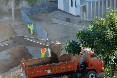 Excavator loading a dump truck with soil Stock Photos