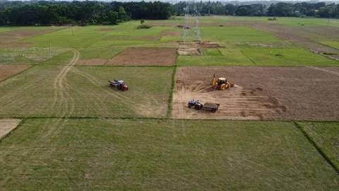 Excavator Loading Earth into Tractor Trailer in Agricultural Field. Video stock 335790760