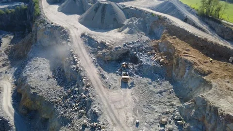 Excavator Loading Granite into Dump Truck at Quarry – Drone Orbit Stock Footage 347948772