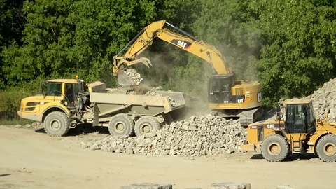 Excavator loading gravel to a dump truck... | Stock Video | Pond5