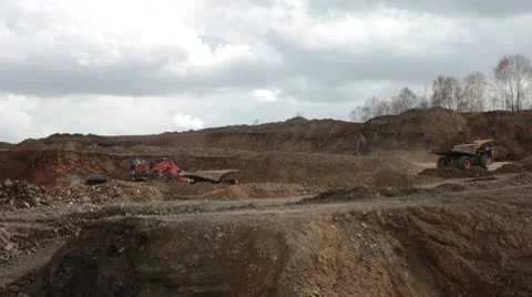 Excavator loading huge dump trucks Stock Footage 10756394