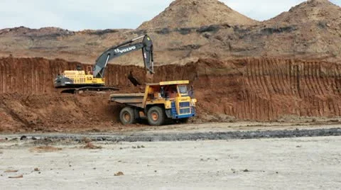 Excavator loading huge dump trucks Stock Footage 10756524