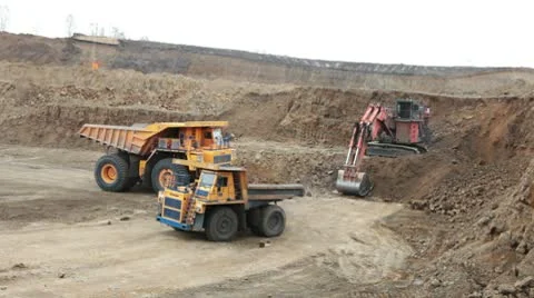 Excavator loading huge dump trucks Stock Footage 10756715