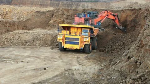 Excavator loading huge dump trucks Stock Footage 10756735