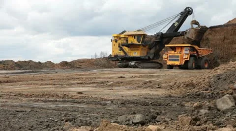 Excavator loading huge dump trucks Stock Footage 10756933