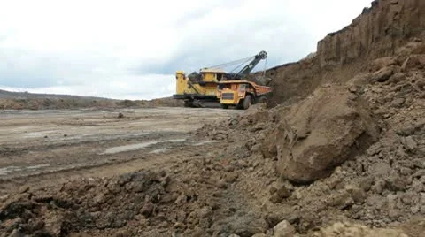 Excavator loading huge dump trucks Stock Footage 10757068