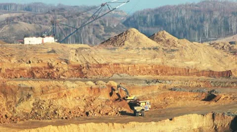 Excavator loading huge dump trucks Stock Footage 10757277