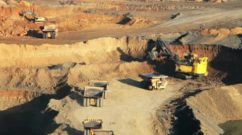 Excavator loading huge dump trucks Stock Footage 10767035