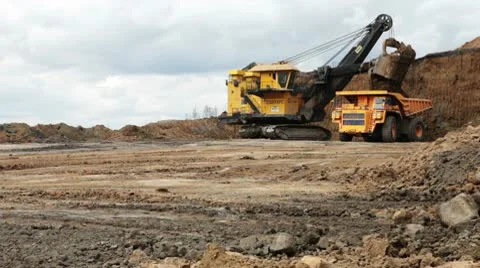 Excavator loading huge dump trucks Stock Footage 10767281
