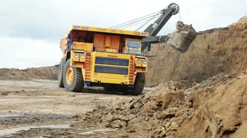 Excavator loading huge dump trucks Stock Footage 10767314