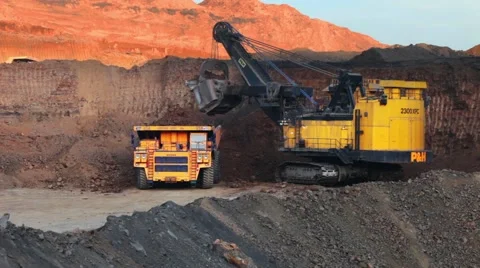 Excavator loading huge dump into trucks Stock Footage 49387643