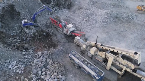 Excavator Loading Rocks into Crusher in a Quarry in Finland during Spring Stock Footage 339043998