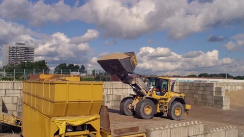 Excavator loading sand into a container at construction site Video stock 81537570