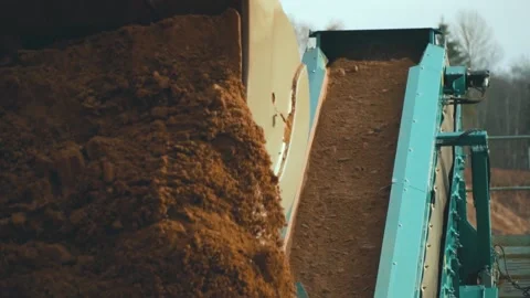 Excavator loading sand into conveyor . Tractor in sand quarry Video stock 237184089