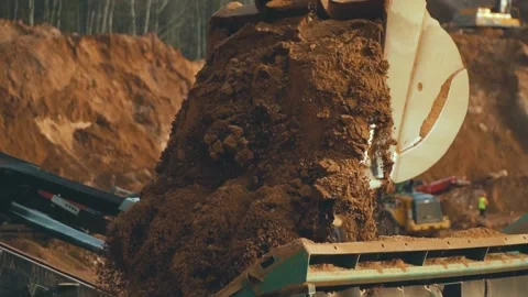 Excavator loading sand into conveyor . Tractor in sand quarry Video stock 239263178