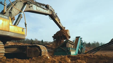 Excavator loading sand into conveyor . Tractor in sand quarry Stock-Footage 243735990