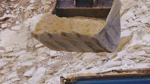 Excavator loading sand in a mine. 動画素材 123180386