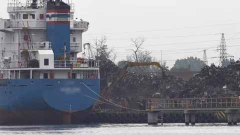 Excavator Loading Scrap Metal on Cargo Ship Stock Footage 111066917