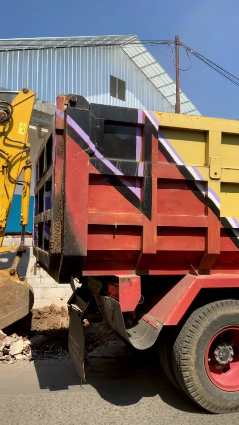 Excavator Loading Soil into Dump Truck at Construction Site Stock Footage 339645643