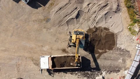 Excavator loading soil into a dump truck on construction site Stock Footage 344646123