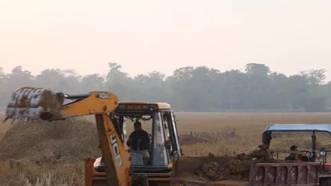 Excavator Loading Soil into Tractor in Rural Assam India Stock Footage 326857346