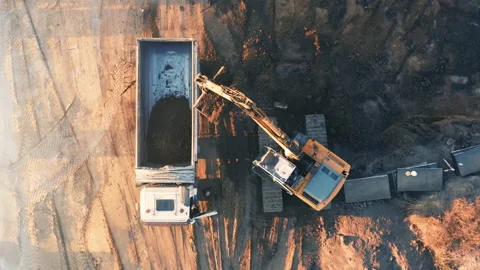 Excavator loading soil into a truck on a development land (building plot) Stock Footage 169059541