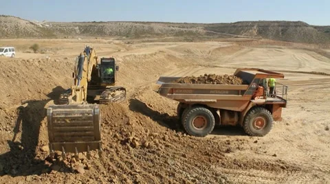 Excavator loading a truck with dirt Stock Footage 8648632
