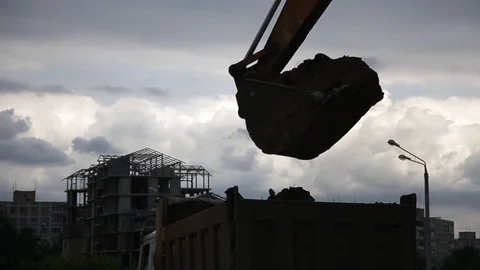Excavator loading truck with ground at the construction site. Stock Footage 78183995