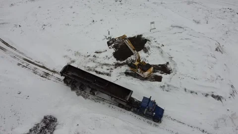 Excavator loading a truck in the snow Video stock 255853763