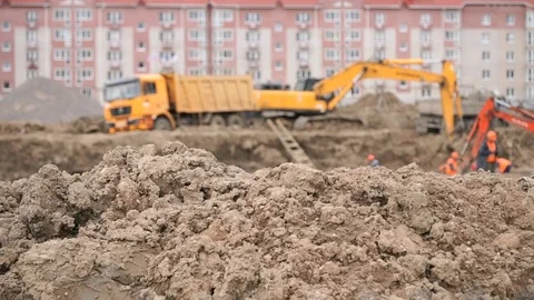Excavator loads clay using bucket into dump truck Stock Footage 77631250