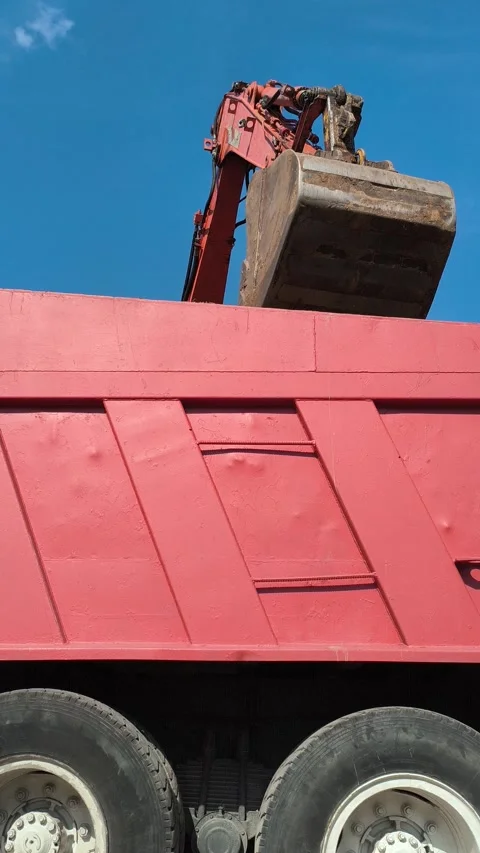 Excavator loads earth into a truck using a bucket. Preparing a construction site Stock Footage 310057211