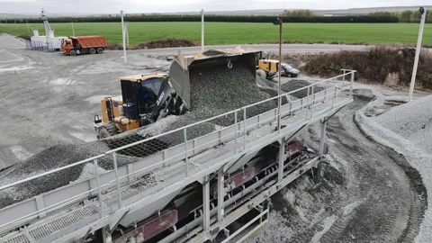 Excavator loads granite grains in sorting machine at quarry Stock Footage 237026543