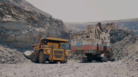 Excavator loads iron ore into a mining truck Stock Footage 116775667