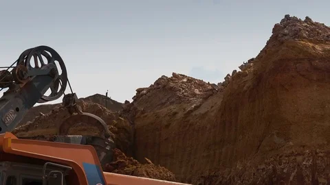 Excavator loads ore into dump-truck. .This area has been mined for buaxite Stock Footage 75310349