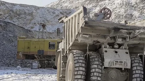 Excavator loads ore into dump-trucks. Stock-Footage 63545406