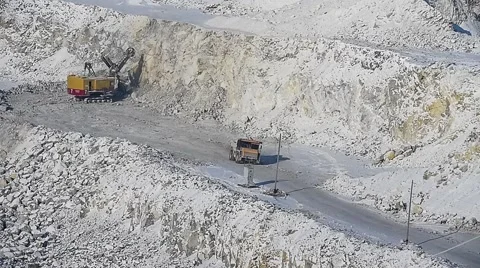 Excavator loads ore into dump-trucks. Pan. Video stock 63545432