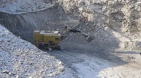 Excavator loads ore into dump-trucks. Pan. Stock Footage 63545477
