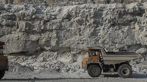 Excavator loads ore into dump-trucks. Stock Footage 63545705